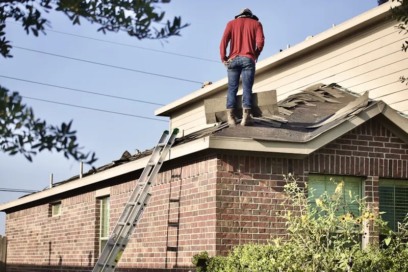 Professional roofer working on a residential roof in Willow Springs